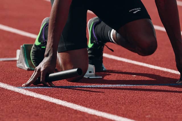 Photo of an athlete in his starting blocks. Big-Picture and Design-Level Event Storming workshop are really about making the best start possible when building systems with Domain-Driven Design (DDD)