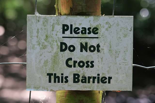 Photo of a panel written 'Please, do not cross this barrier'. Similarly, there is a fine line between Rough Design Up Front and pushing Event Storming too far to do Big Design Up Front.