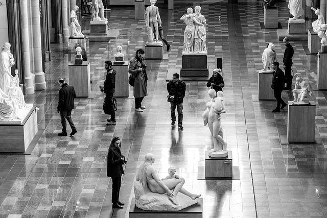 Photo of visitors walking around in a museum gallery. Start the Event Storming session by pairing people for a "Hot Beverage Gallery Walk" so that they reconnect with co-participants and what was done before.